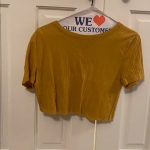 Yellow cropped tee shirt.